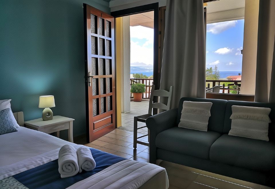 a bedroom with a bed , nightstand , and sliding glass door leading to an outdoor patio at Sofia Kalyves