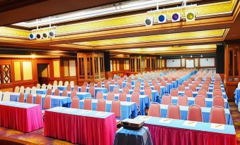 a large conference room with rows of chairs and tables set up for a meeting or event at Asian Hotel