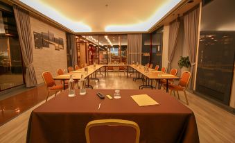 a conference room set up for a meeting , with multiple chairs arranged in rows and a table in the center at Hotel Diplomatic