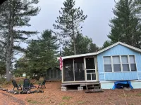 Parkmodel cabin w screened porch in campground on bike trail.