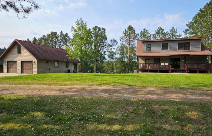 Three bedroom hide-a-way with spacious deck over looking Island Lake.