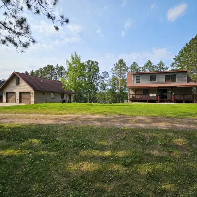 Three bedroom hide-a-way with spacious deck over looking Island Lake.