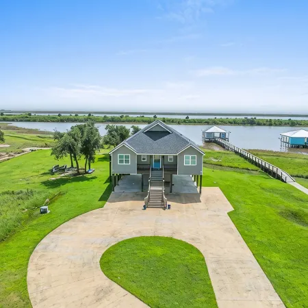REEL N  REST in Hackberry LA ! Waterfront home with beautiful views .