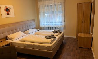 a hotel room with two beds , one on the left side of the room and the other on the right side at Hotel Zur Post Limburg Bad Camberg