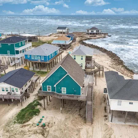 Martinis & Bikinis, a beach front house with toes in the sand drink in the hand.