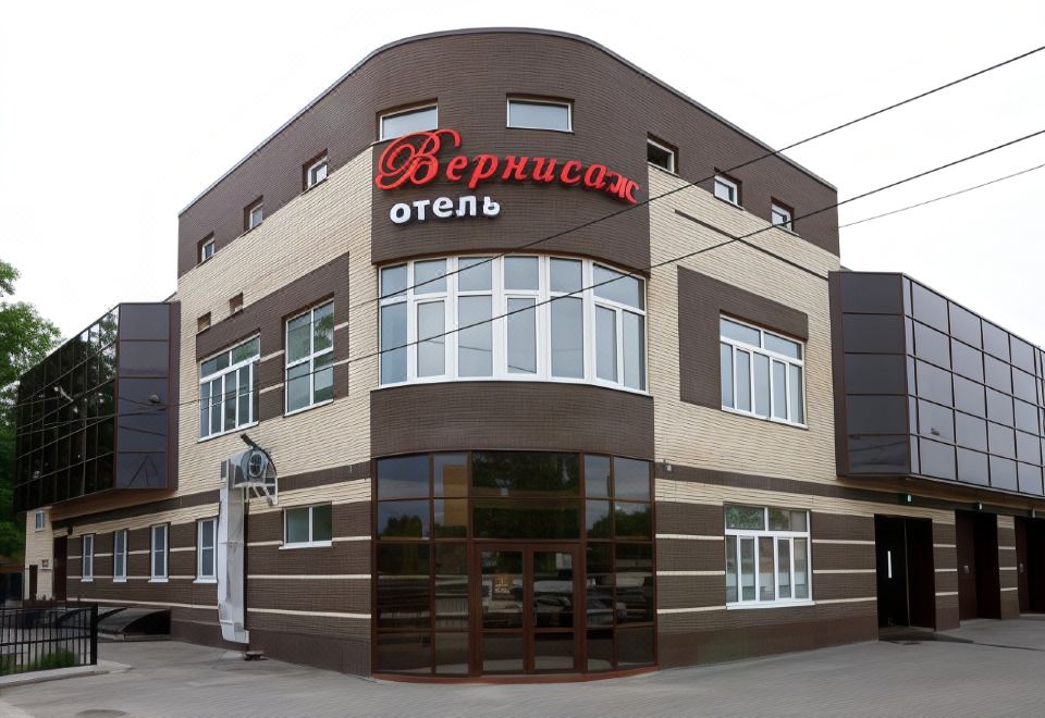 "a brown building with a red sign that says "" beercaysko "" and another sign that says "" oleg ""." at Vernisage