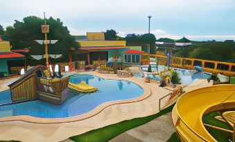 an outdoor water park with a large pool , a slide , and a play area for children at Hotel La Hacienda