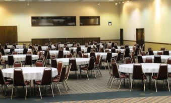 a large dining hall with numerous tables and chairs arranged for a group of people at The Inn at Silvercreek