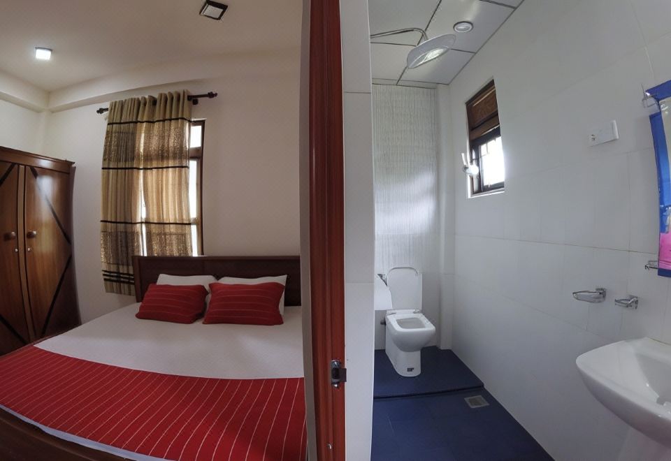a small bathroom with a toilet and a sink , as well as a bed in the bedroom at Heaven Rest