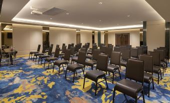 A spacious room with rows of chairs in the center, suitable for hosting events or conferences at Aira Hotel Bangkok Sukhumvit 11