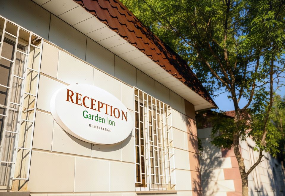 "a building with a sign that reads "" reception garden inn "" prominently displayed on the front" at Garden Inn Resort Sevan