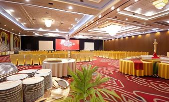 a large conference room with tables and chairs set up for a meeting or event at The Rich Jogja Hotel