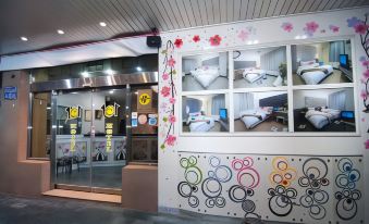 a storefront with a colorful and whimsical design , featuring circular patterns on the wall and two windows at 101 Hotel