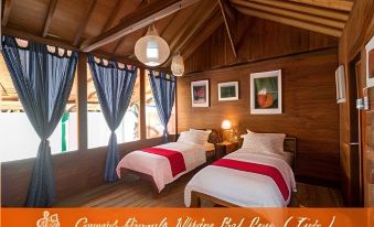 a bedroom with two beds , one on the left side and the other on the right side of the room at Coconut Island Carita