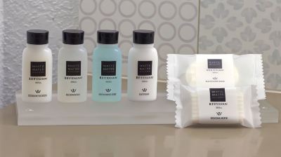 "a set of three bottles and a small bag with the text "" white collection "" on them" at Country Inn & Suites by Radisson, Watertown, SD