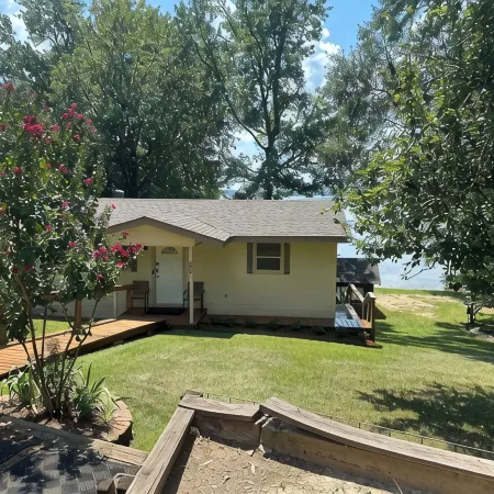 Peaceful lake front home with wrap around porch and relaxing views!