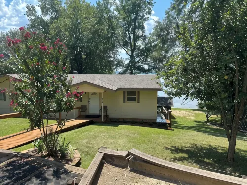 Peaceful lake front home with wrap around porch and relaxing views!