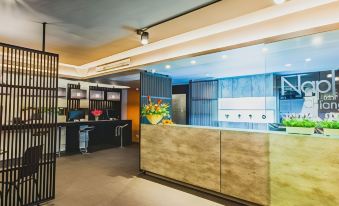 a modern reception area with a marble counter and a large vase of flowers on top at NAP in Fest