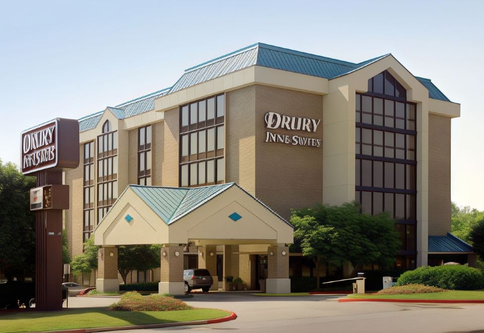 "a large hotel building with a sign that reads "" drury inn & suites "" prominently displayed on the front" at Drury Inn & Suites Atlanta Morrow