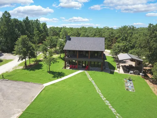 Richland Chambers Lakefront 2-story home with boat dock and pavilions.