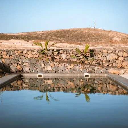 An architectural oasis with large swimming pool, along a breath-taking scenery.