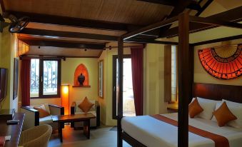 a modern hotel room with wooden walls , large windows , and a white bed in the center of the room at Rikitikitavi