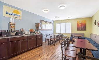 a spacious , well - lit cafeteria with wooden floors , large windows , and a bar area , decorated in various colors and materials at Days Inn by Wyndham Wrightstown McGuire AFB/Bordentown