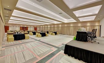 a large conference room with multiple tables and chairs set up for a meeting or event at The Fern Residency Aurangabad