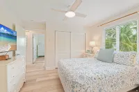 Charming cottage with heated pool, tropical landscaping in prime location.