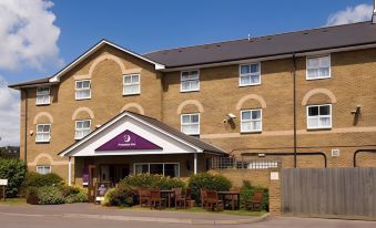 a building with a purple awning and several tables outside , set against a clear blue sky at Margate