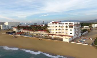 a large hotel situated on the beach , with a swimming pool visible in the area at Hotel Marbella