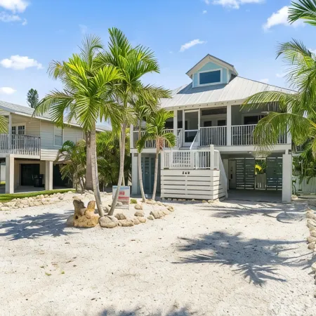 Charming cottage with heated pool, tropical landscaping in prime location.