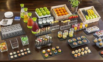 a dining table with a variety of desserts , including cakes , cupcakes , and other sweet treats at NH Vienna Airport Conference C