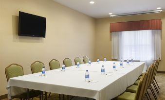 a conference room with a long table , chairs , and water bottles set up for a meeting at Country Inn & Suites by Radisson, Ashland - Hanover, VA