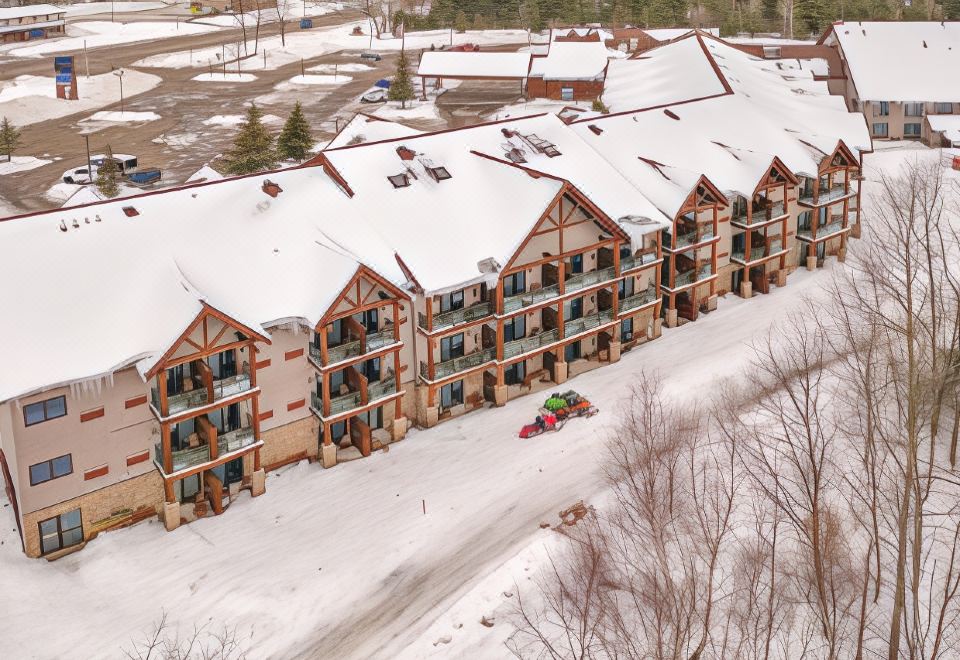 a bird 's eye view of a building with many balconies and cars parked in the driveway at The Waters of Minocqua