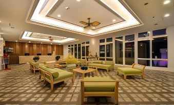 a large , well - lit room with multiple couches and chairs arranged in various positions , creating a comfortable and inviting atmosphere at J Resort