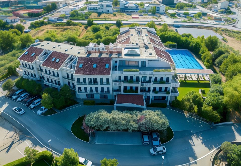 a large building with a red roof is surrounded by trees and a parking lot at Hotel President Solin