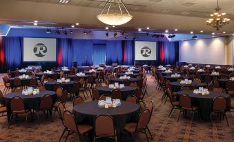 a large conference room with tables and chairs set up for a meeting or event at Bismarck Hotel and Conference Center