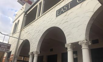 "a white building with a sign that reads "" east church "" prominently displayed on the front" at Charlton Motel