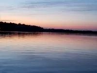 Three bedroom hide-a-way with spacious deck over looking Island Lake.
