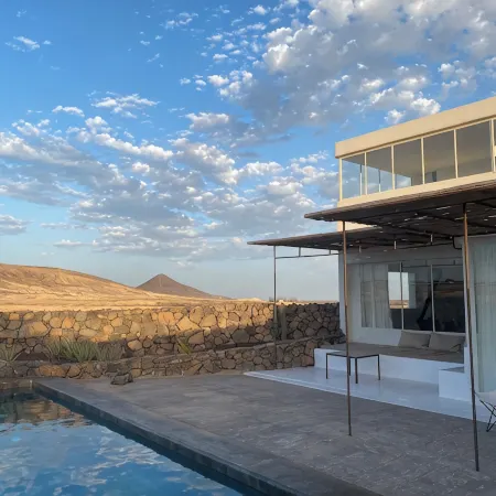 An architectural oasis with large swimming pool, along a breath-taking scenery.