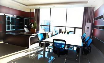a modern office space with a large window , multiple chairs , and a long table in the center at Park Hotel