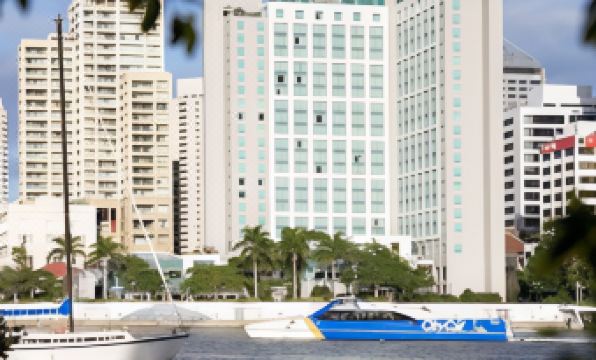 a body of water with boats floating on it , surrounded by tall buildings in the background at Stamford Plaza Brisbane