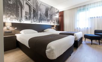 a hotel room with two beds , one on the left and one on the right side of the room at Bastion Hotel Bussum Hilversum