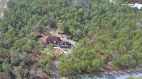 Escape to this serene 4-bedroom home set on 10 private acres.
