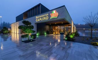 "a large , modern restaurant with a red sign that reads "" restaurants camino "" prominently displayed on the front of the building" at Hotel A