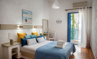 a bedroom with a large bed , blue and white bedding , and a door leading to an outdoor area at Amazona