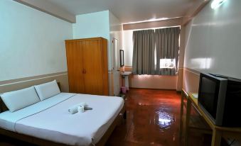 a clean and well - lit bedroom with a large bed , wooden furniture , and a window with curtains at My Hotel