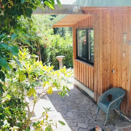 Modernly Furnished Bungalow with Fireplace, Surrounded by Greenery.