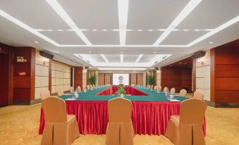 a large conference room with multiple tables and chairs arranged for a meeting or event at Golden Hotel